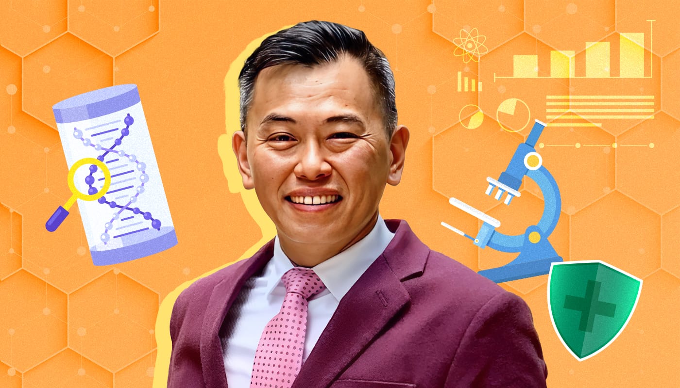 A man in a maroon suit and pink tie stands in front of scientific icons including a DNA strand, microscope, and green shield.