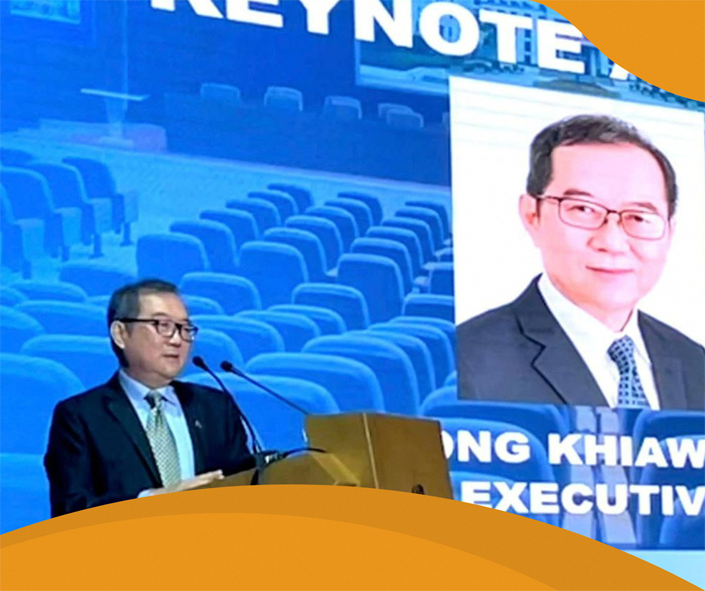 Mr Ong Khiaw Hong delivering a keynote address at a conference.