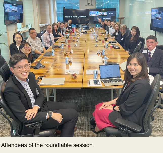 Participants seated around a table during professional roundtable discussion session.
