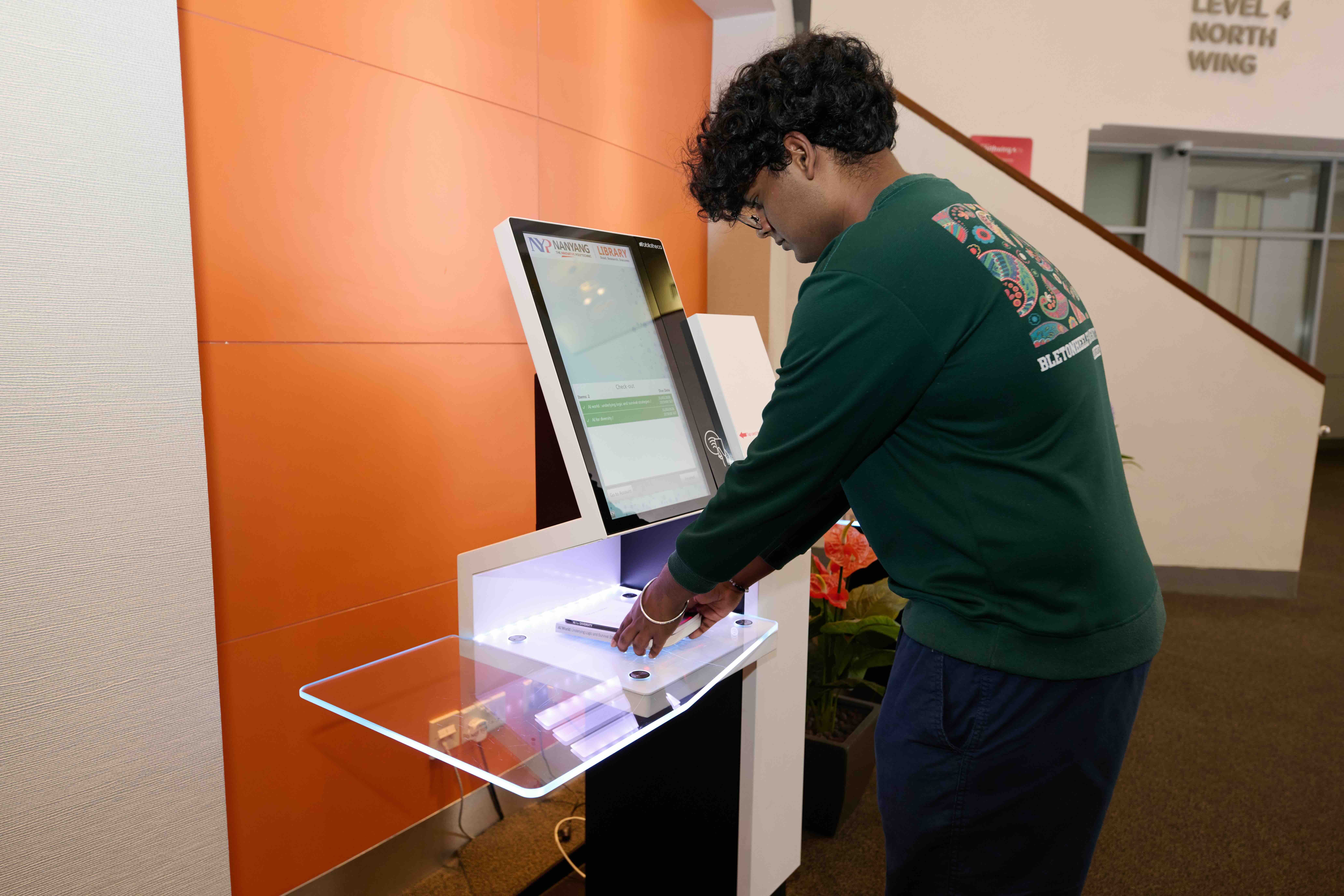 Student at self-check machine