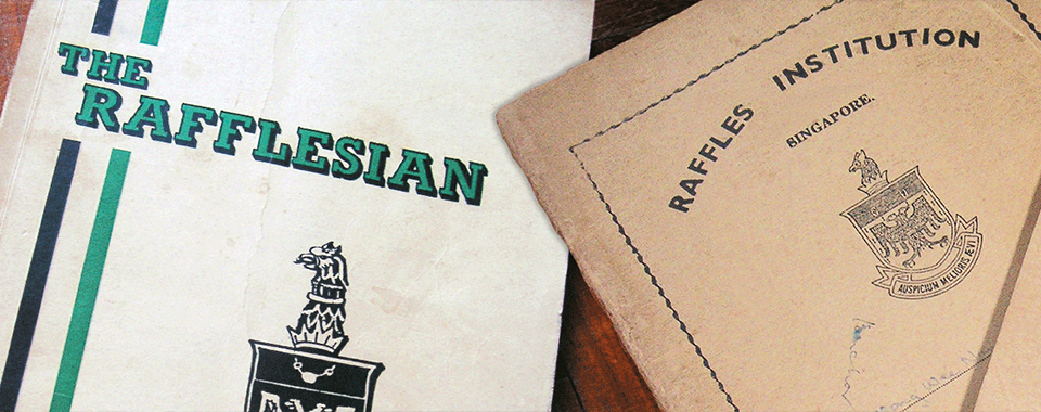 Two aged publications: "The Rafflesian" magazine and a worn "Raffles Institution Singapore" booklet with crests.