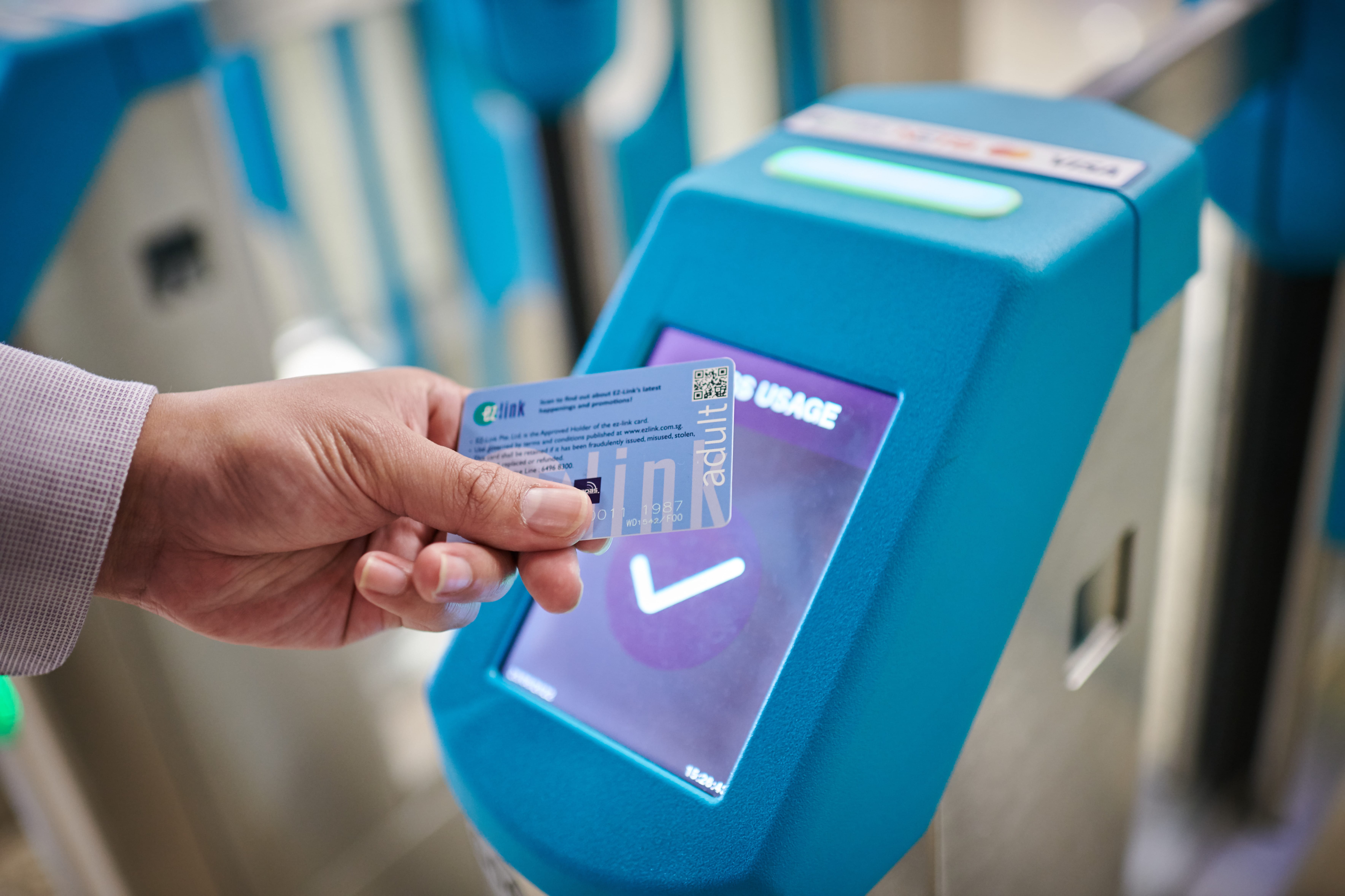 A man tapping out of MRT gantry using an EZ-link card
