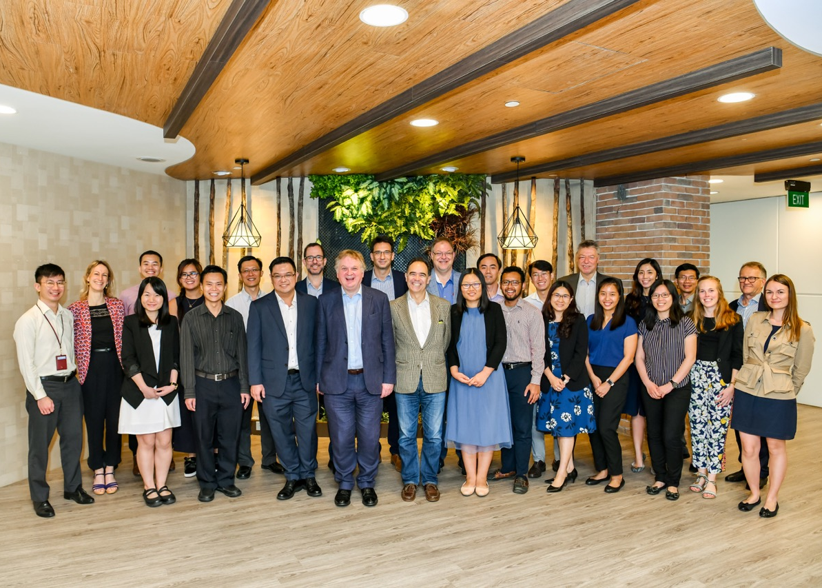Group photo of PTC and international delegates at a meeting in Singapore.