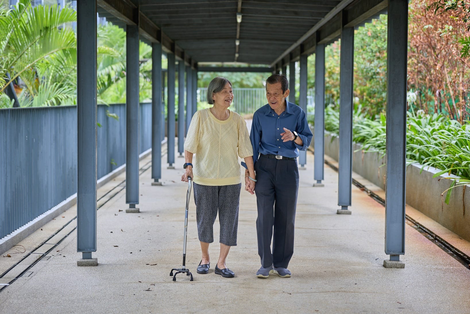 Elderly couple walking in a sheltered walkway