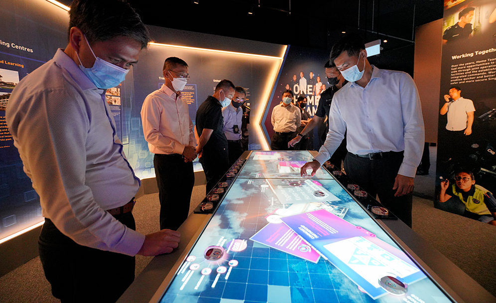 Men wearing masks interacting with digital screens