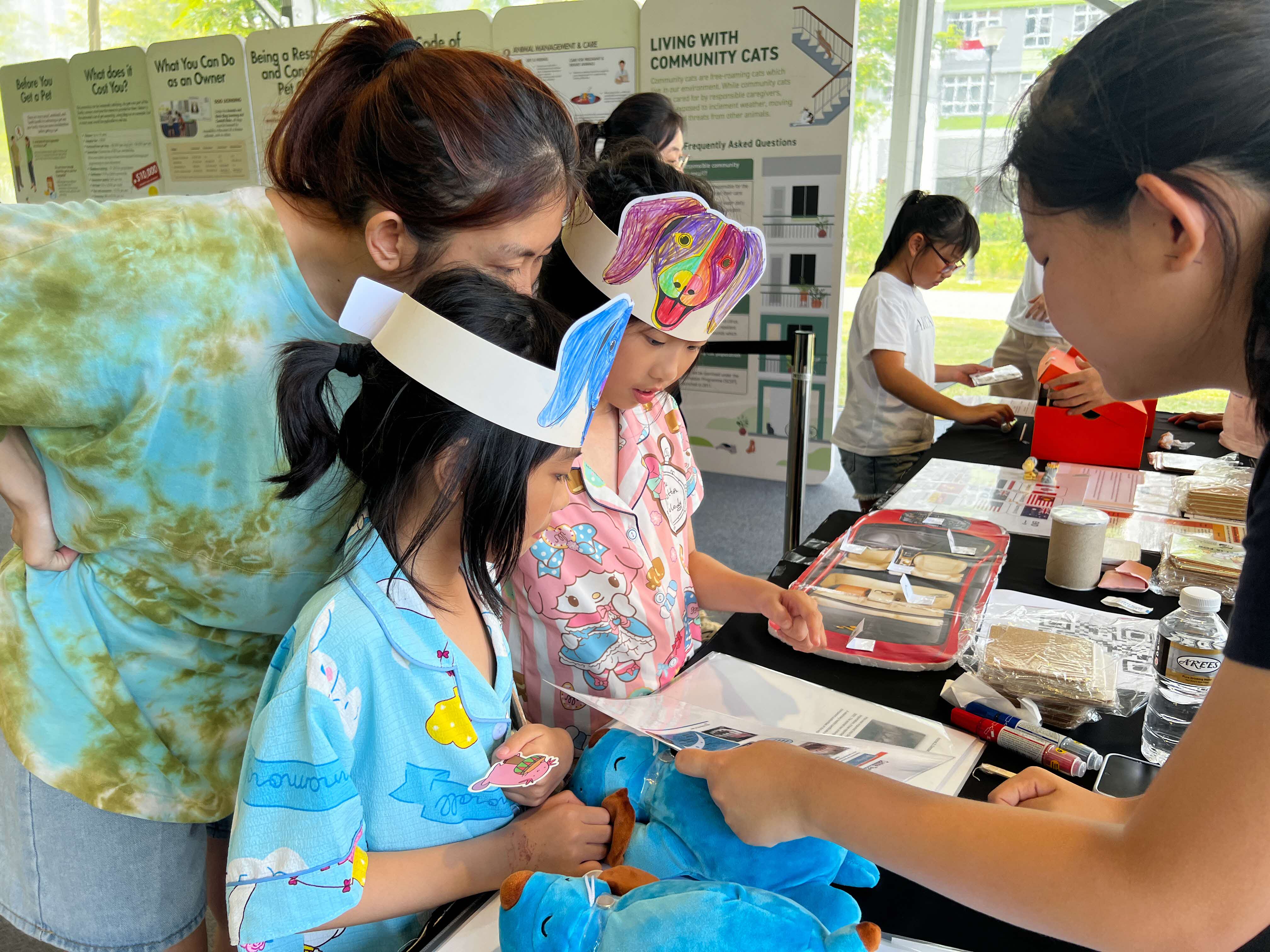 A photograph of 2 girls at a booth at an event