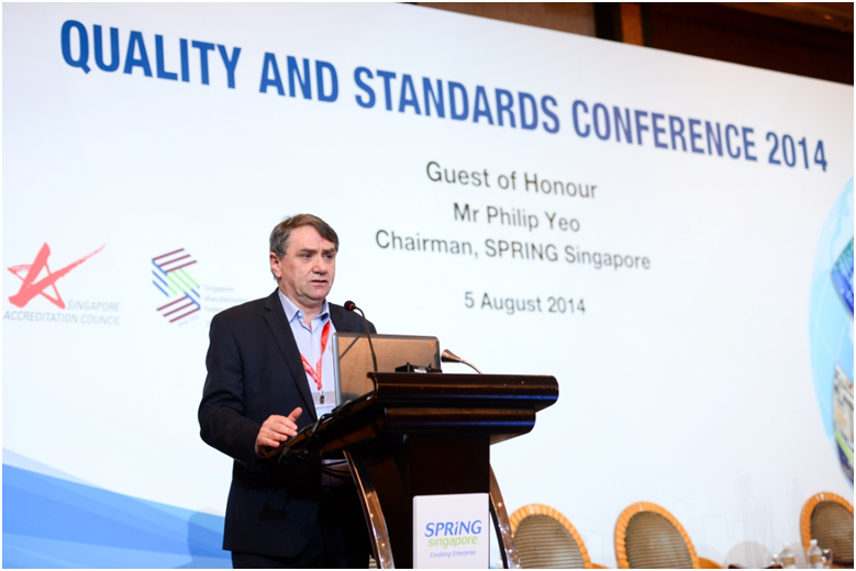 A man speaks at a podium at the Quality and Standards Conference 2014 on 5 August in Singapore.