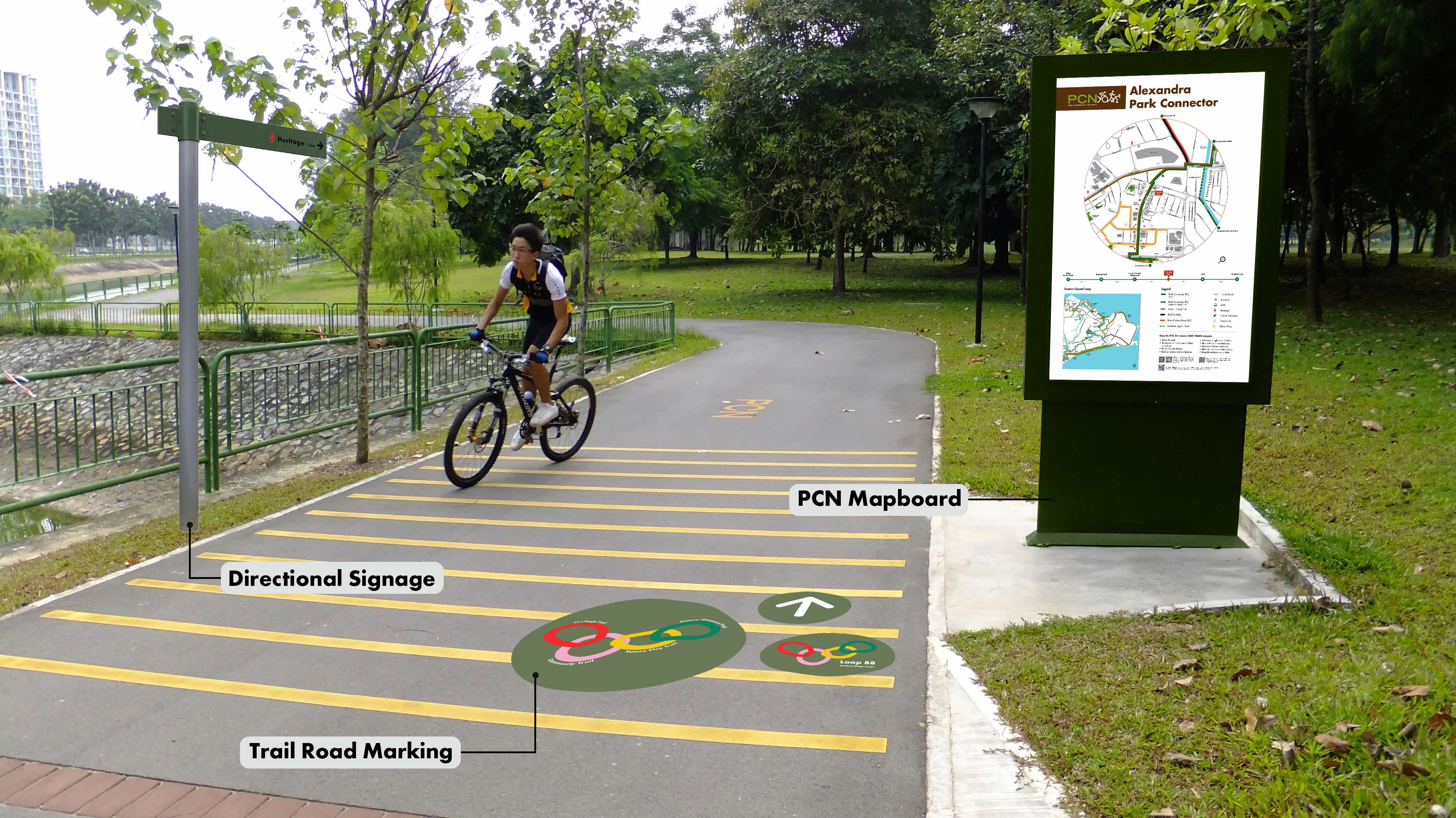 A cyclist rides on a park trail with directional signage, trail road markings, and a mapboard for Alexandra Park Connector.