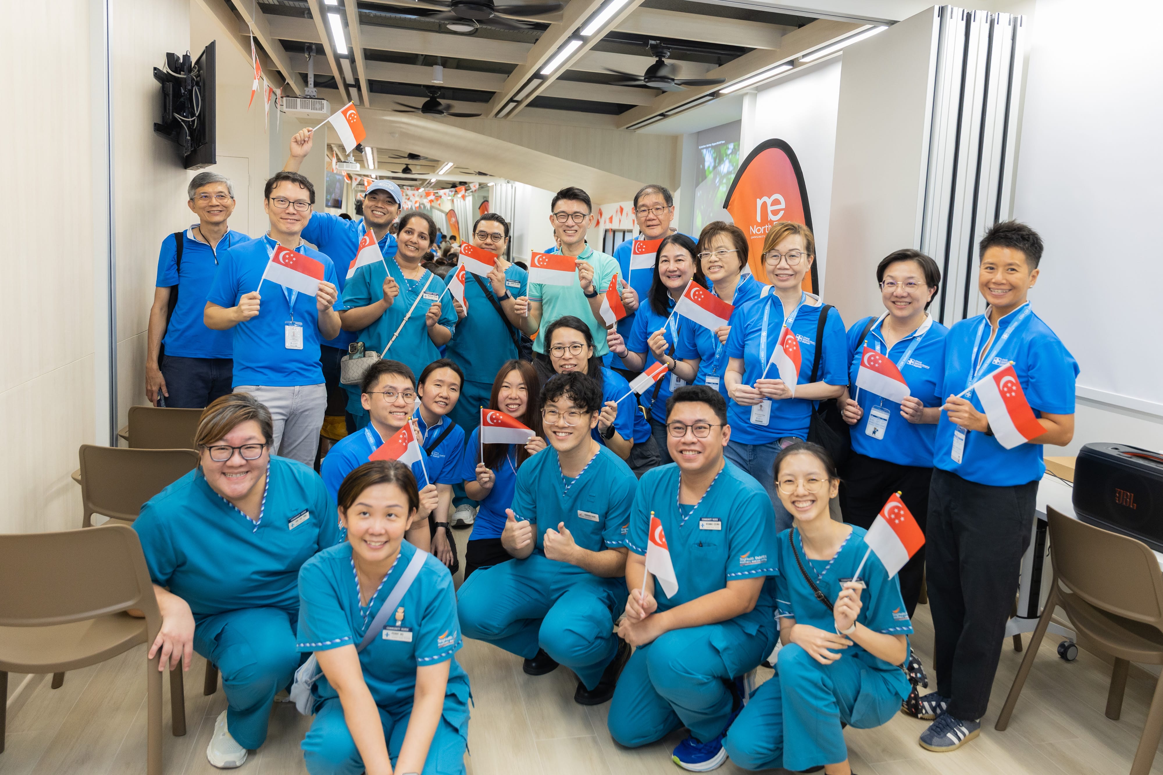 A group shot of Mr Baey Yam Keng, healthcare professionals and community partners