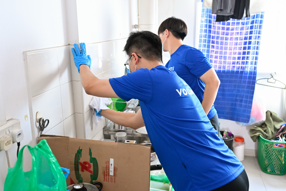 Volunteers scrubbing walls clean
