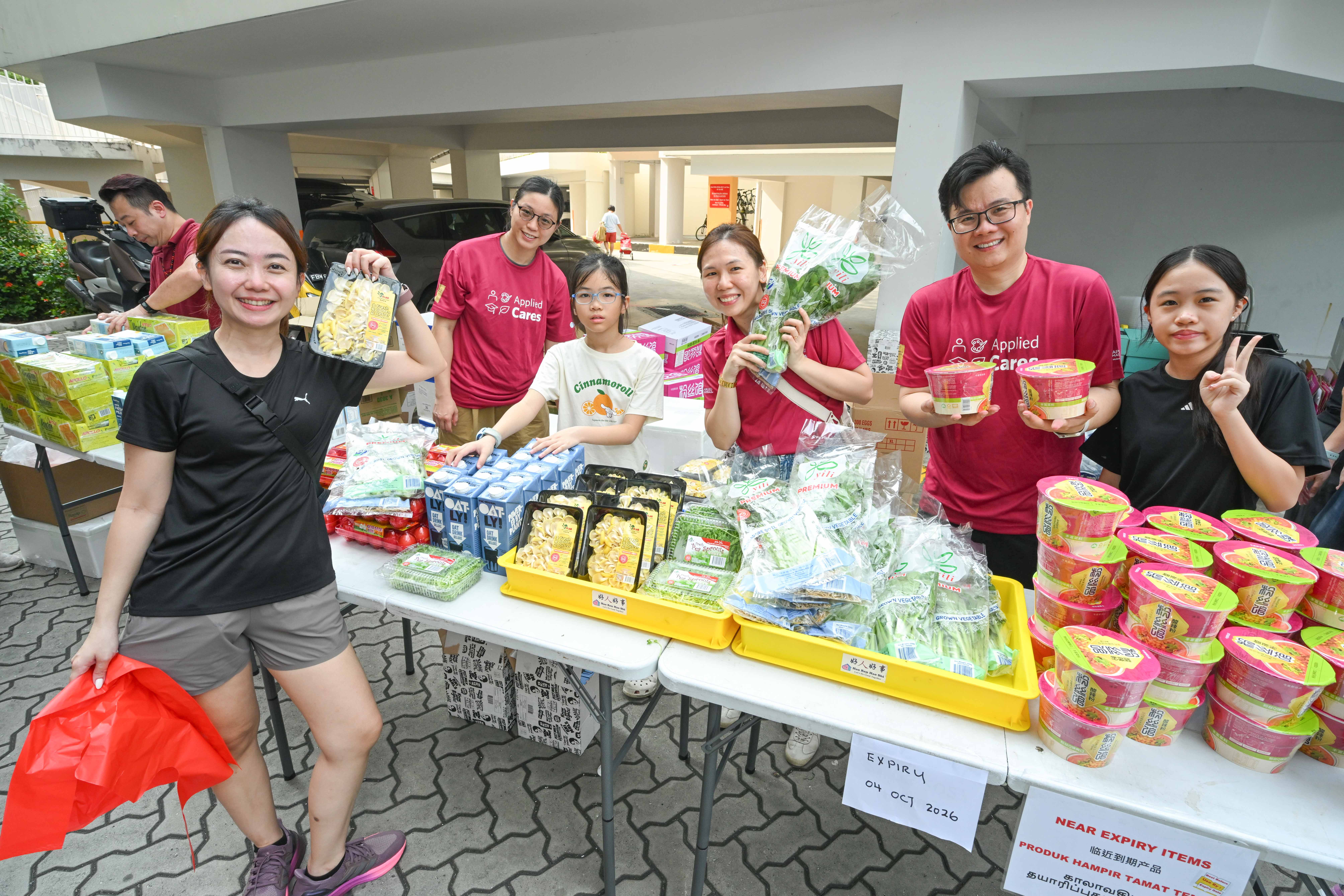 Volunteers pose with groceries