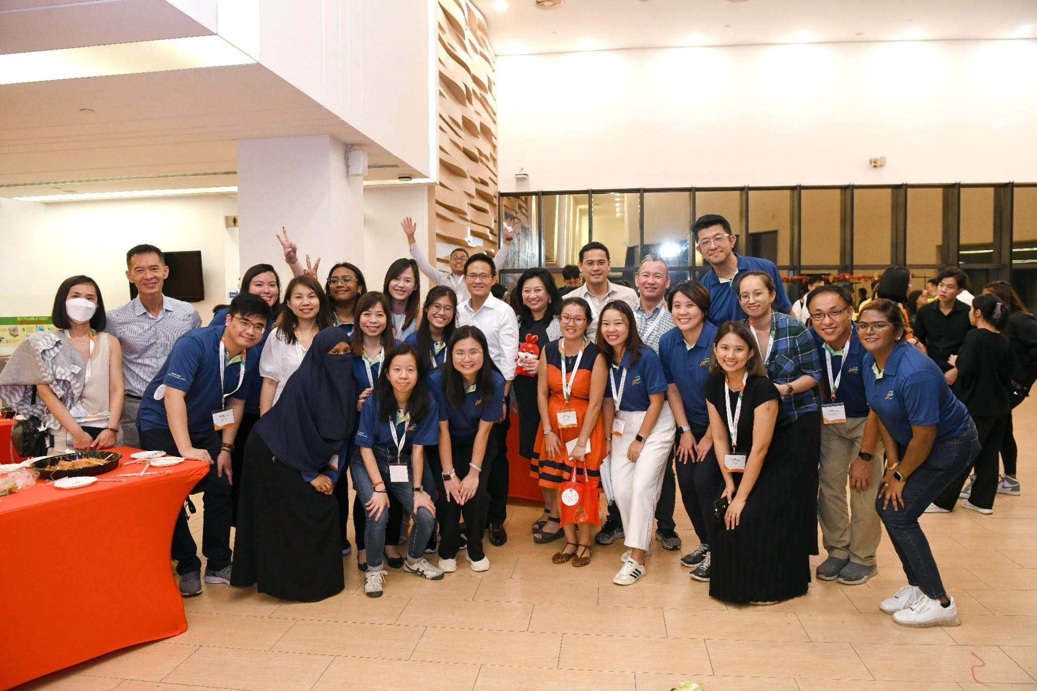 Group photo of NECDC staff at the district meeting, gathered indoors for a photo.