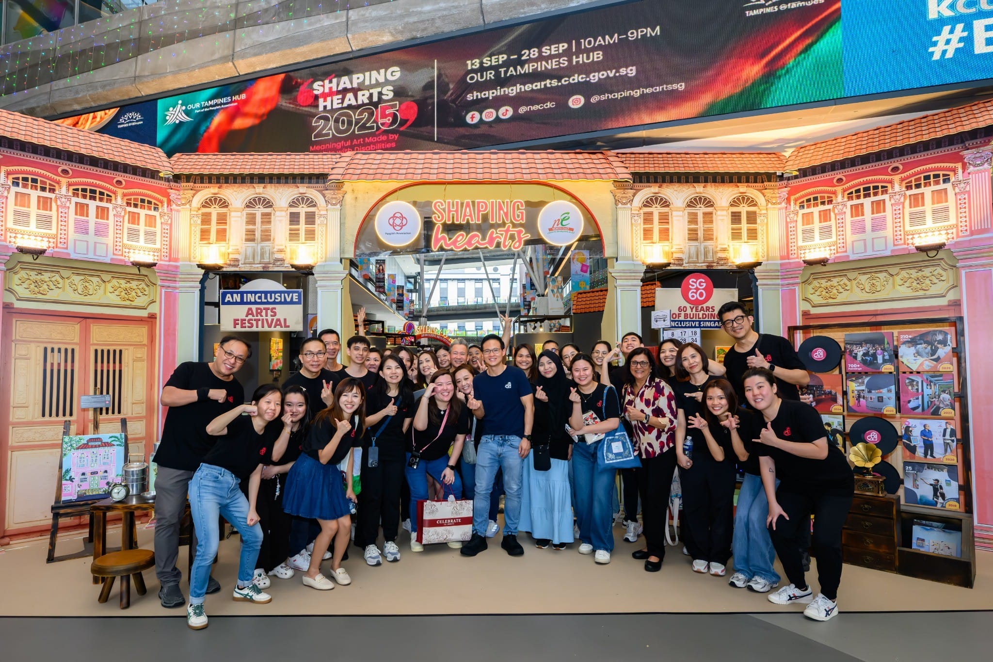 Group photo of participants at the Shaping Hearts 2025 inclusive arts festival, gathered at the event entrance in a mall to celebrate community, creativity, and inclusion.