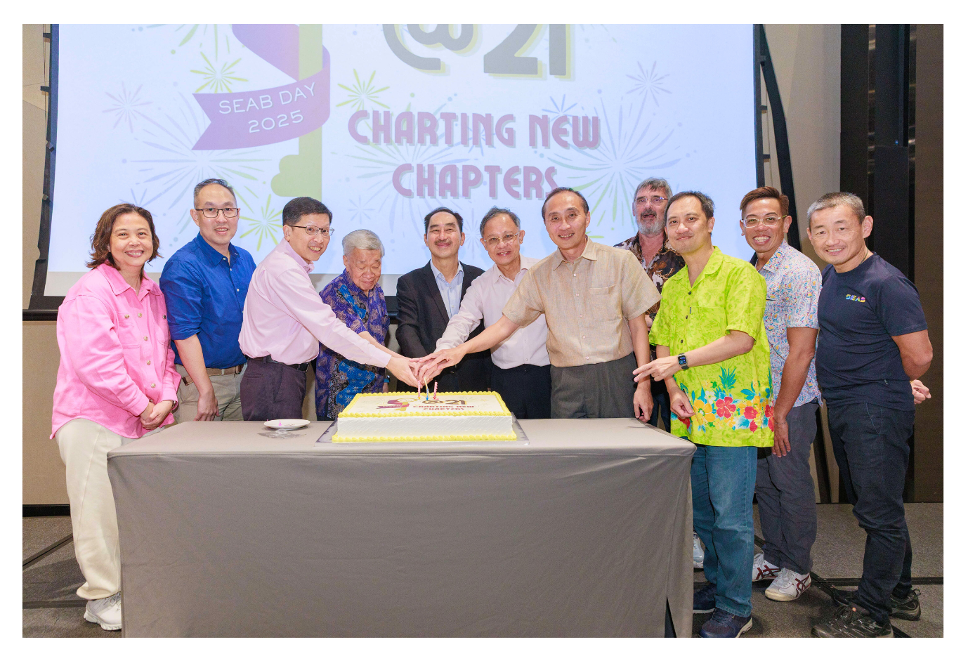 Cake-cutting ceremony featuring Board members, retirees and senior management members