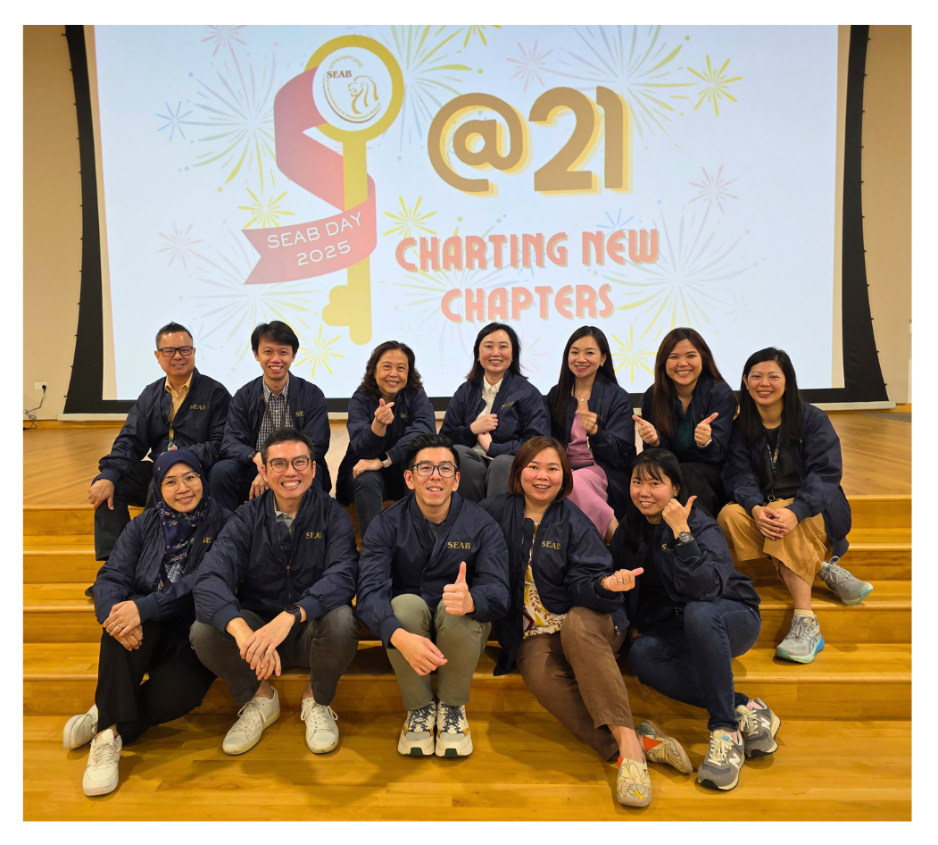 The 2025 SEAB Day Organising Committee donning the SEAB jackets, one of the door gifts presented to staff.