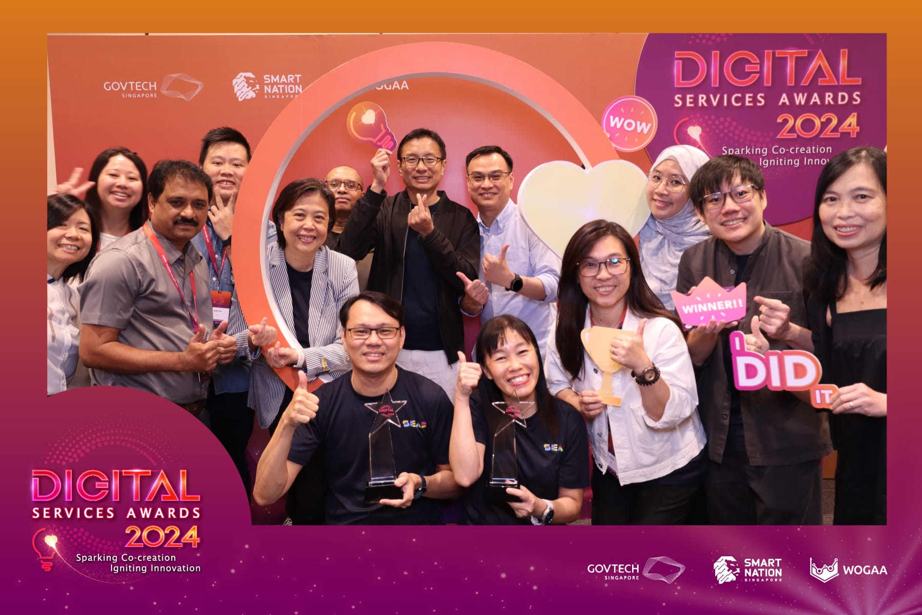 A group of people at the Digital Services Awards 2024 event holding various awards and celebratory signs.