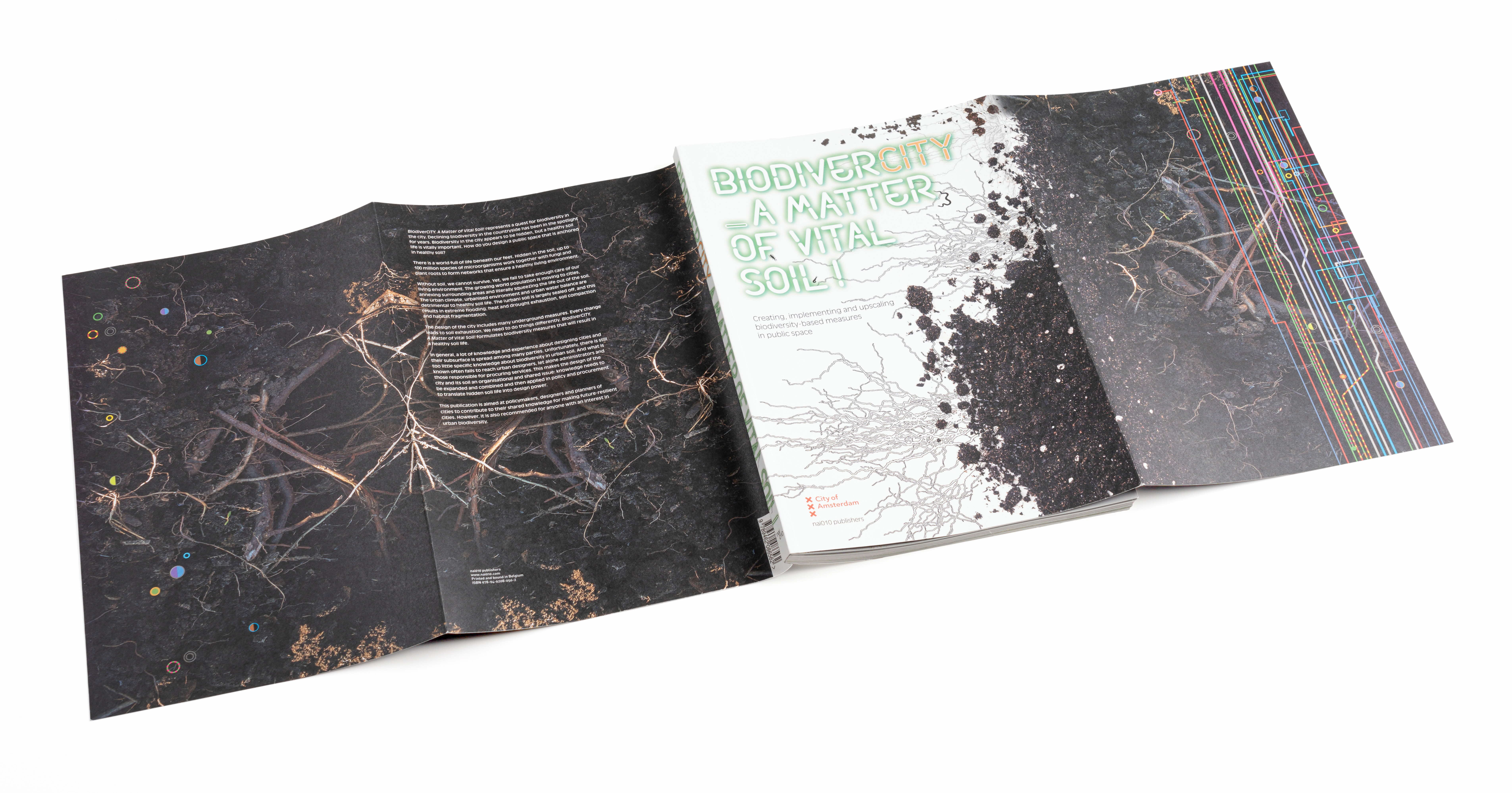 Open book titled "BiodiversCity - A Matter of Vital Soil" showing dark pages with root imagery and colorful lines.