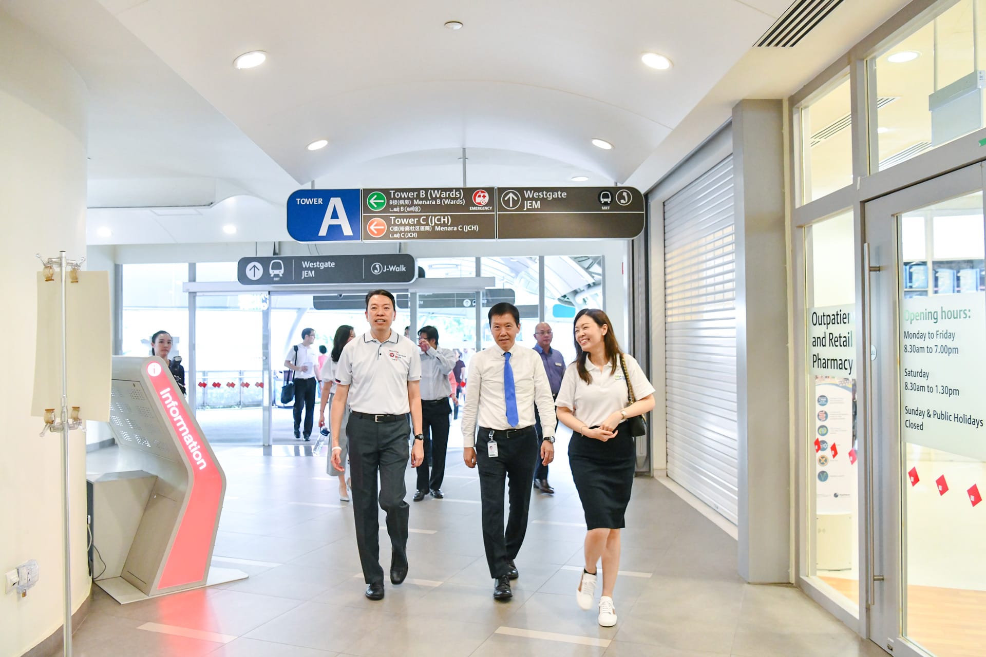 Portrait of Mr Melvin Yong and two other individuals walking 