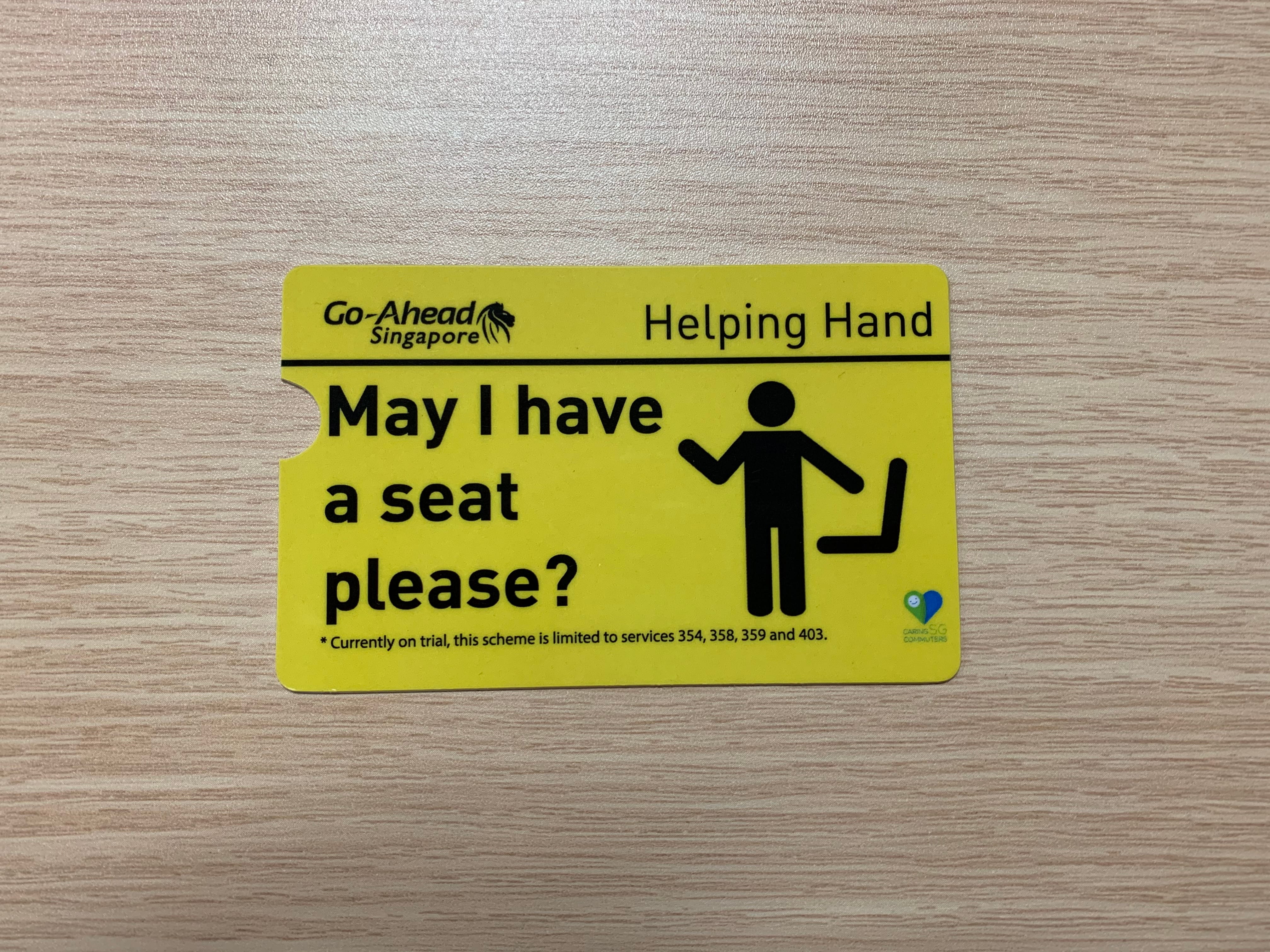A Go-Ahead Singapore yellow Helping Hand card