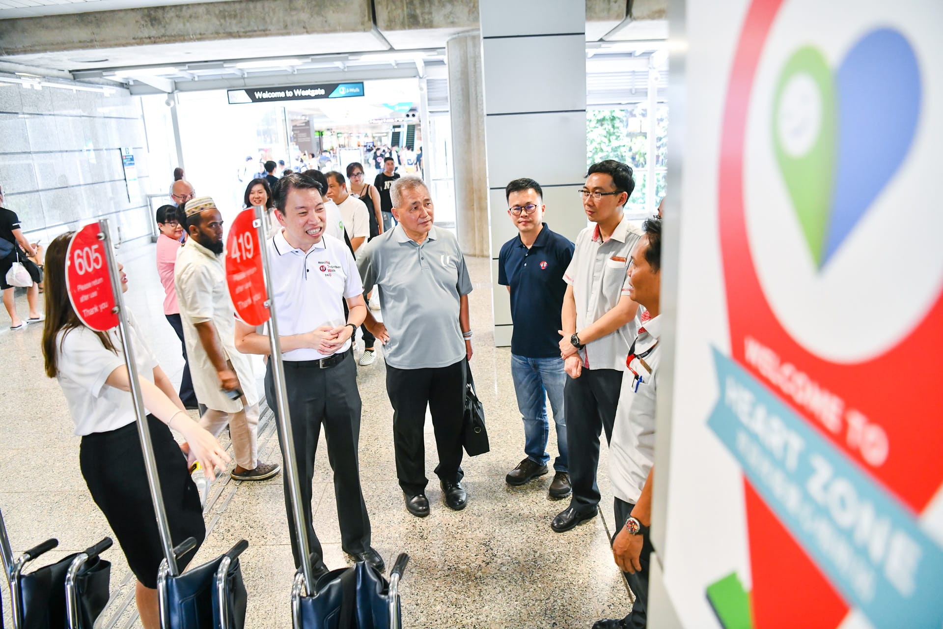 Photo of Mr Melvin Yong speaking to a small group of people around the Heart Zone at Jurong East