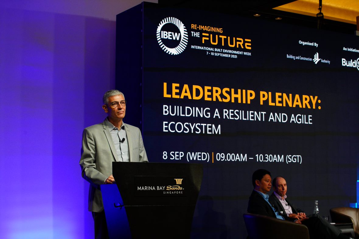 Man at Marina Bay Sands podium presenting for "Leadership Plenary" at IBEW's "Re-Imagining The Future."