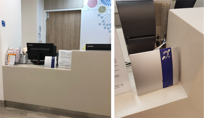 Reception desk with Lenovo computers and Hearing Loop sign.