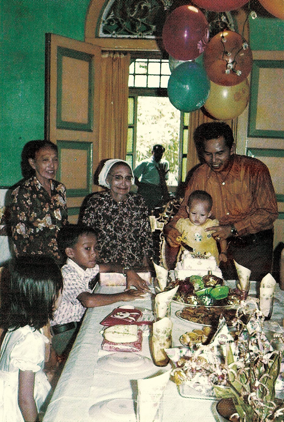 Hidayah Amin celebrating her first birthday at Gedung Kuning in 1973. In the photo are four generations of Haji Yusoff’s family. From the left: Hidayah’s grandmother, her great-grandmother and her father. The boy is a cousin of Hidayah’s mother, while the girl is a guest. Courtesy of Hidayah Amin.