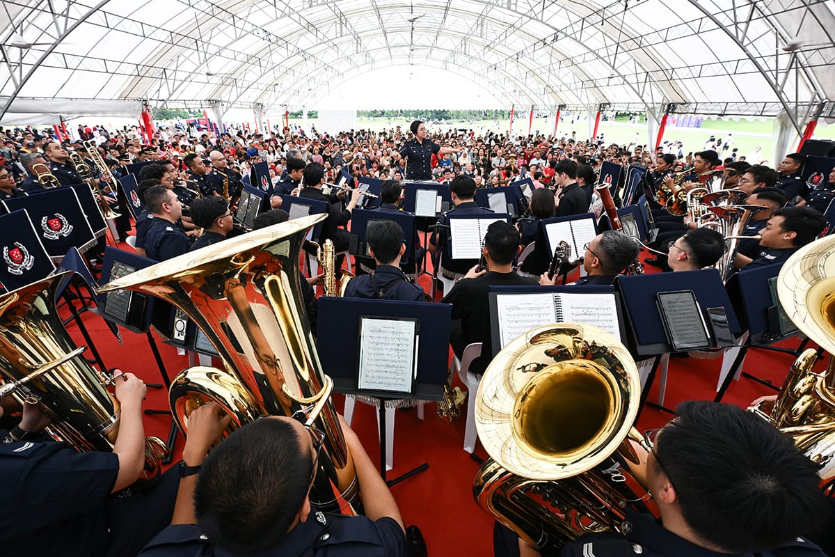 Deputy Superintendent of Police Lau Lifeng conducting the Singapore Police Force Band during the Lunar New Year Istana Open House on 2 February 2025. This performance marked the start of the band’s 100th anniversary series of performances in 2025. Source: The Straits Times © SPH Media Limited. Permission required for reproduction.