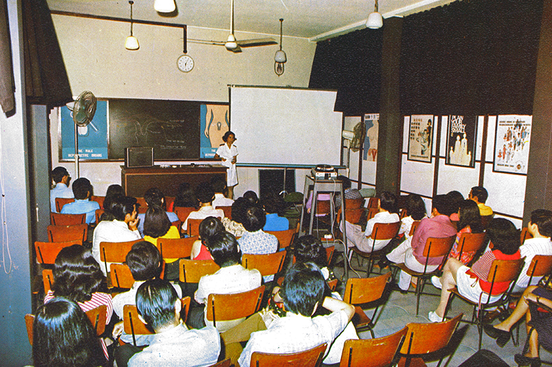 Newlyweds attending a family planning talk. Couples getting hitched at the Registry of Marriages were invited to attend such talks, where they were taught different contraceptive methods and encouraged to stop at two. Image reproduced from Singapore Family Planning and Population Board, Annual Report 1973 (Singapore: Singapore Family Planning and Population Board, 1973), 47. (From National Library, Singapore, call no.: RCLOS 301.426 SFPPBA).