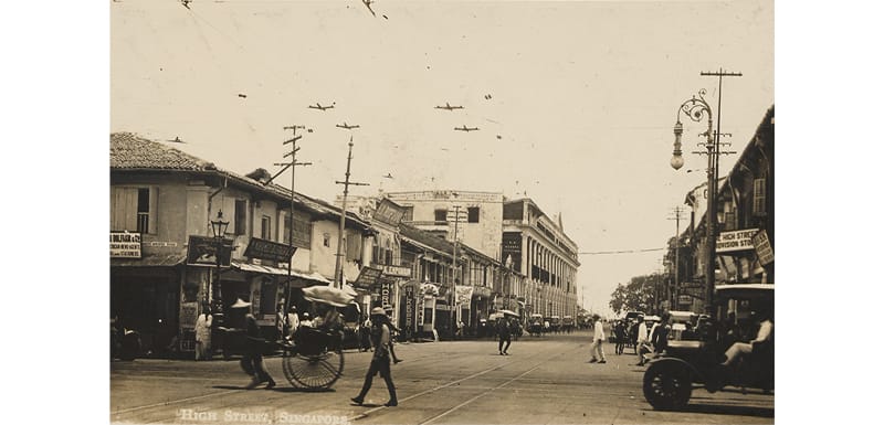 Overhead electric tram lines and an electric lamp along High Street, early 20th century. Lim Shao Bin Collection, PictureSG, National Library, Singapore.
