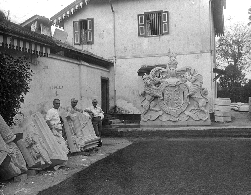 Rodolfo Nolli with his workers at his stoneyard at 47 Scotts Road, 1939. Shown here is the precast cost of arms for Fullerton Building. Lina Brunner Collection, courtesy of National Archives of Singapore (Media - Image no. 19980001358 - 0097).