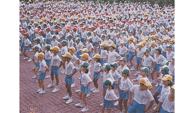 School children doing the Great Singapore Workout on ACES (All Children Exercising Simultaneously) Day in 1993. Image from Ministry of Health Singapore, Annual Report 1993 (Singapore: Ministry of Health, 1994), 30. (From National Library, Singapore, call no. RCLOS 354.59570677 SMHAR-[AR]).