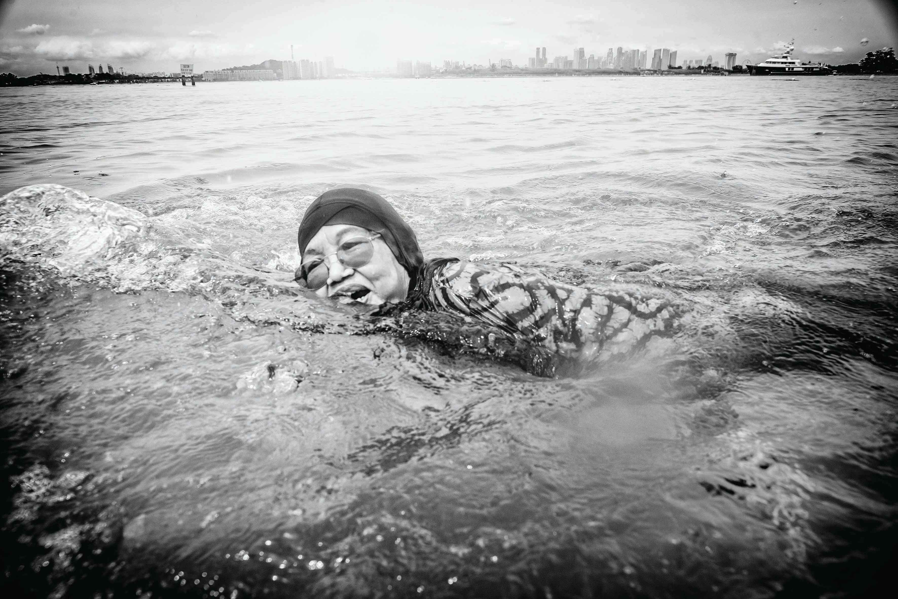 Mdm Bedah bte Din, 76, swims joyfully in the waters off St John Island, once known as Pulau Sekijang Bendera during the recent reunion of former islanders of that cluster. Photo by Edwin Koo.