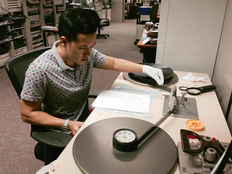 Hand cleaning and inspecting reels of Cathay-Keris films. Courtesy of Asian Film Archive.