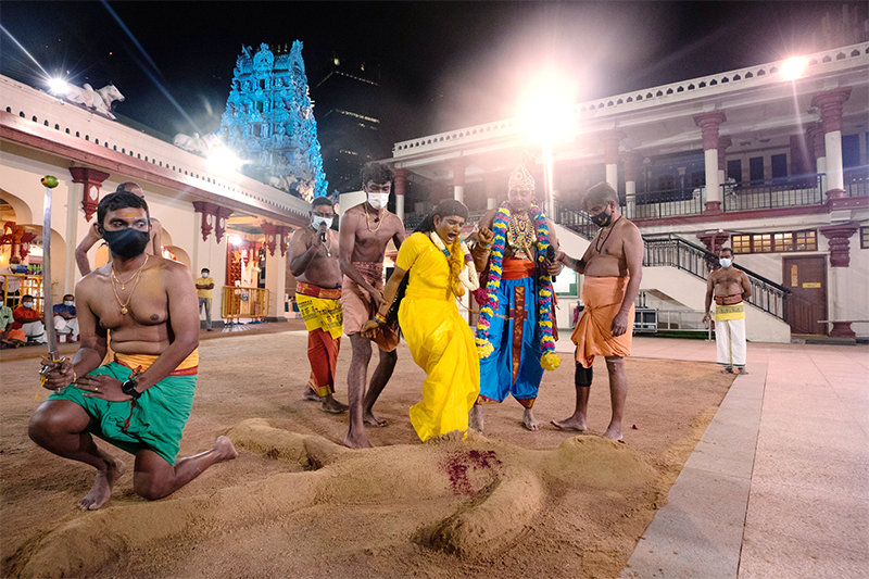 On Padukalam day, an enraged Draupadi (with Krishnan beside her) kicks the effigy of Dushasanan that is lying down on the battlefield, 2021. Courtesy of the Hindu Endowments Board.