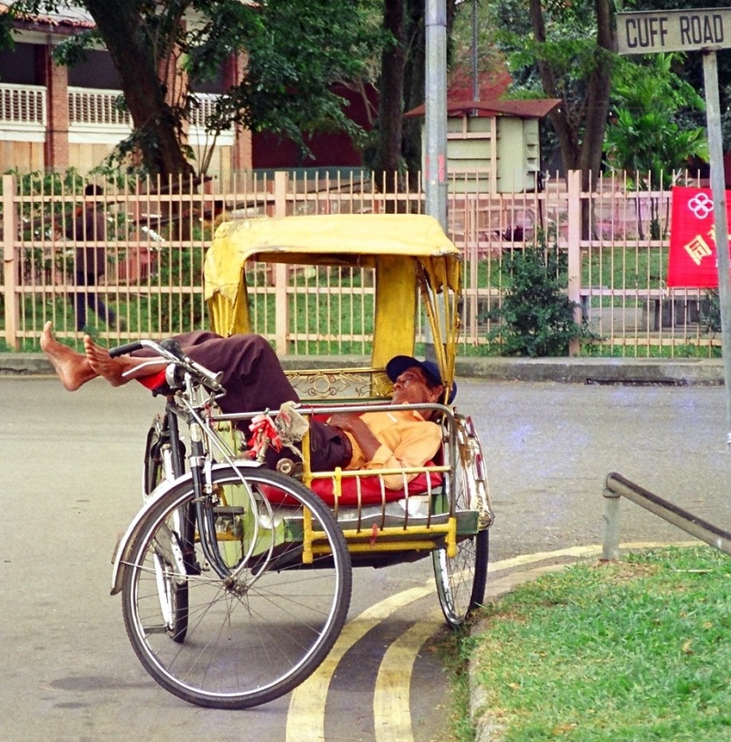 A trishaw rider naps in his trishaw along Cuff Road, 2002. Liesel Strauss Collection, National Library, Singapore.