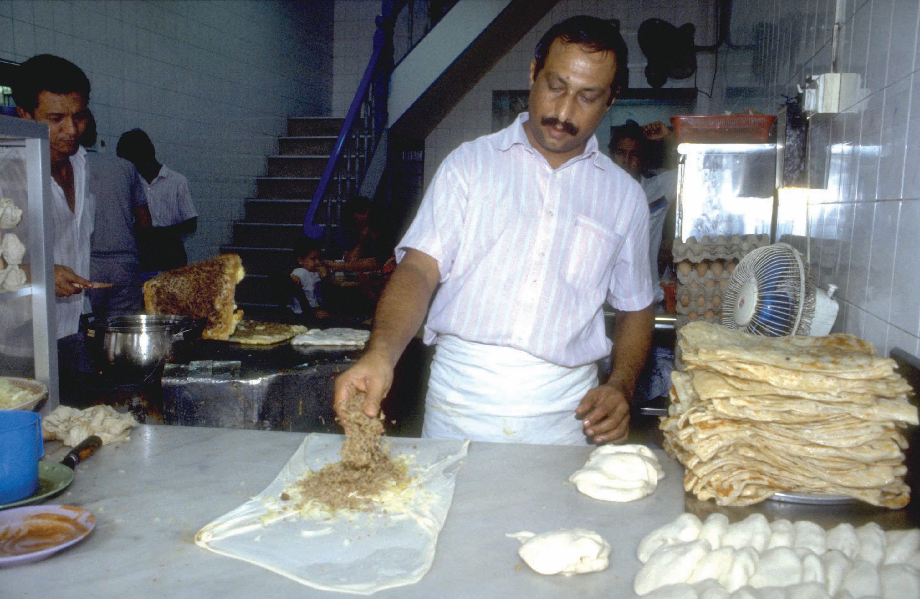 A man making murtatuk in the Kampong Glam area in 1991. Ministry of Information and the Arts Collection, courtesy of National Archives of Singapore. Only The Secret Map of Singapore is available in the National Library collection.