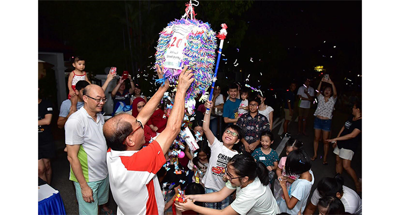 Children taking turns to hit the piñata at Jalan Bintang Tiga’s “Let’s Makan” party in 2019. Courtesy of the Singapore Kindness Movement.