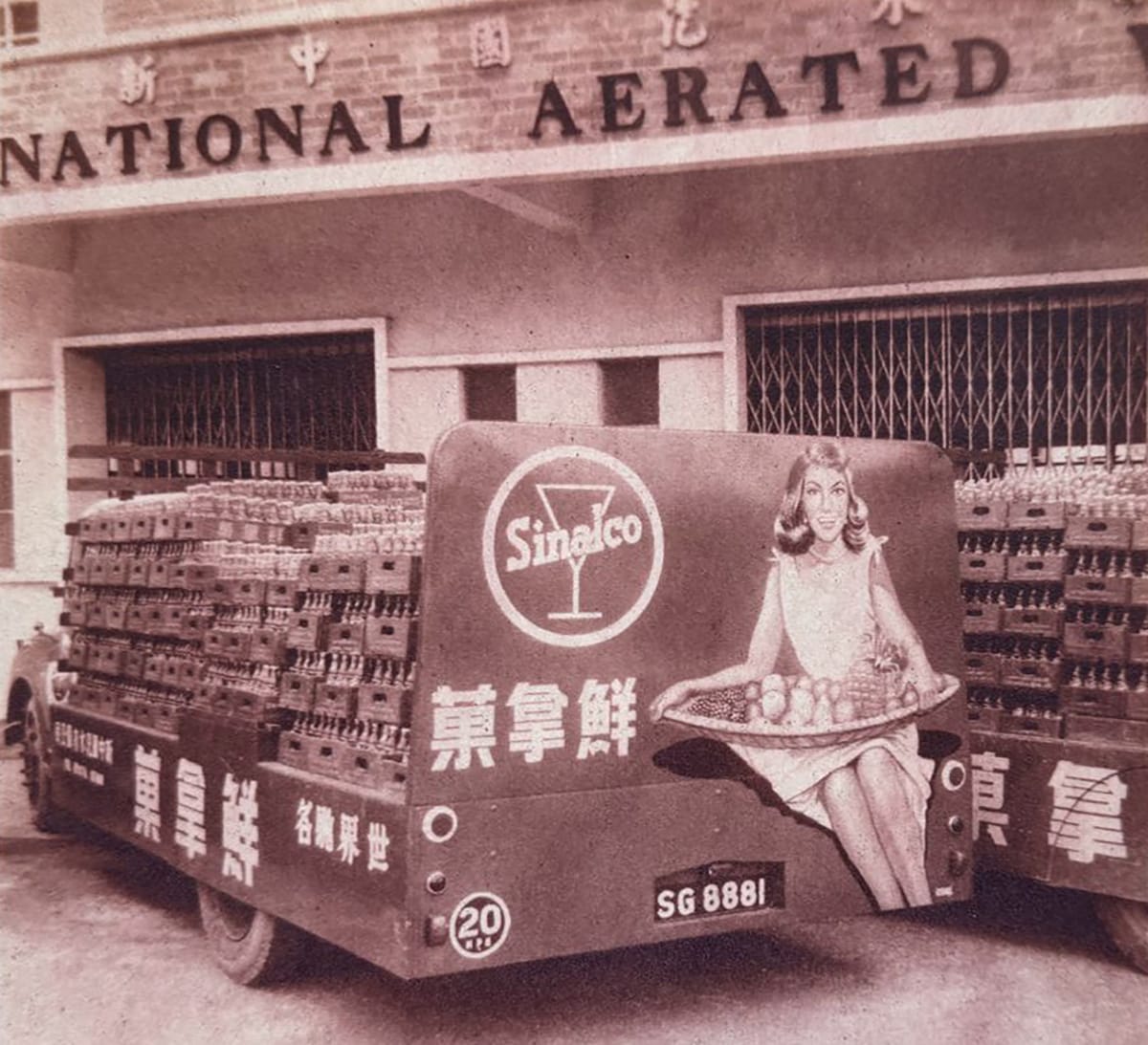 Distribution trucks loaded with crates of Sinalco at the factory of the National Aerated Water Company on Serangoon Road, c. 1950s. Courtesy of URA Collection.
