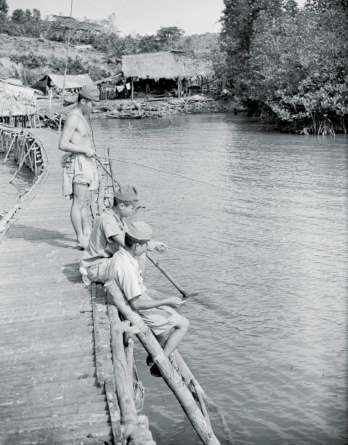 Japanese soldiers fishing using a homemade tackle, 1945. Imperial War Museums (A 30963).