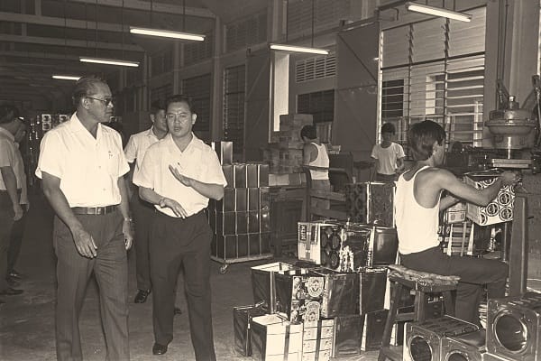 Then Minister for Social Affairs Othman Wok (extreme left) visits the factory of Thye Hong Biscuit in 1975. Ministry of Information and the Arts Collection, courtesy of National Archives of Singapore.