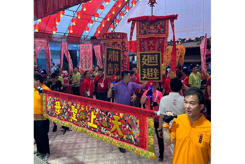 Signs with “Silence” (肃静) and “Retreat” (回避) follow closely behind the banner with Mazu’s title, 天上圣母. Photo by Daryl Lim Wei Jie.