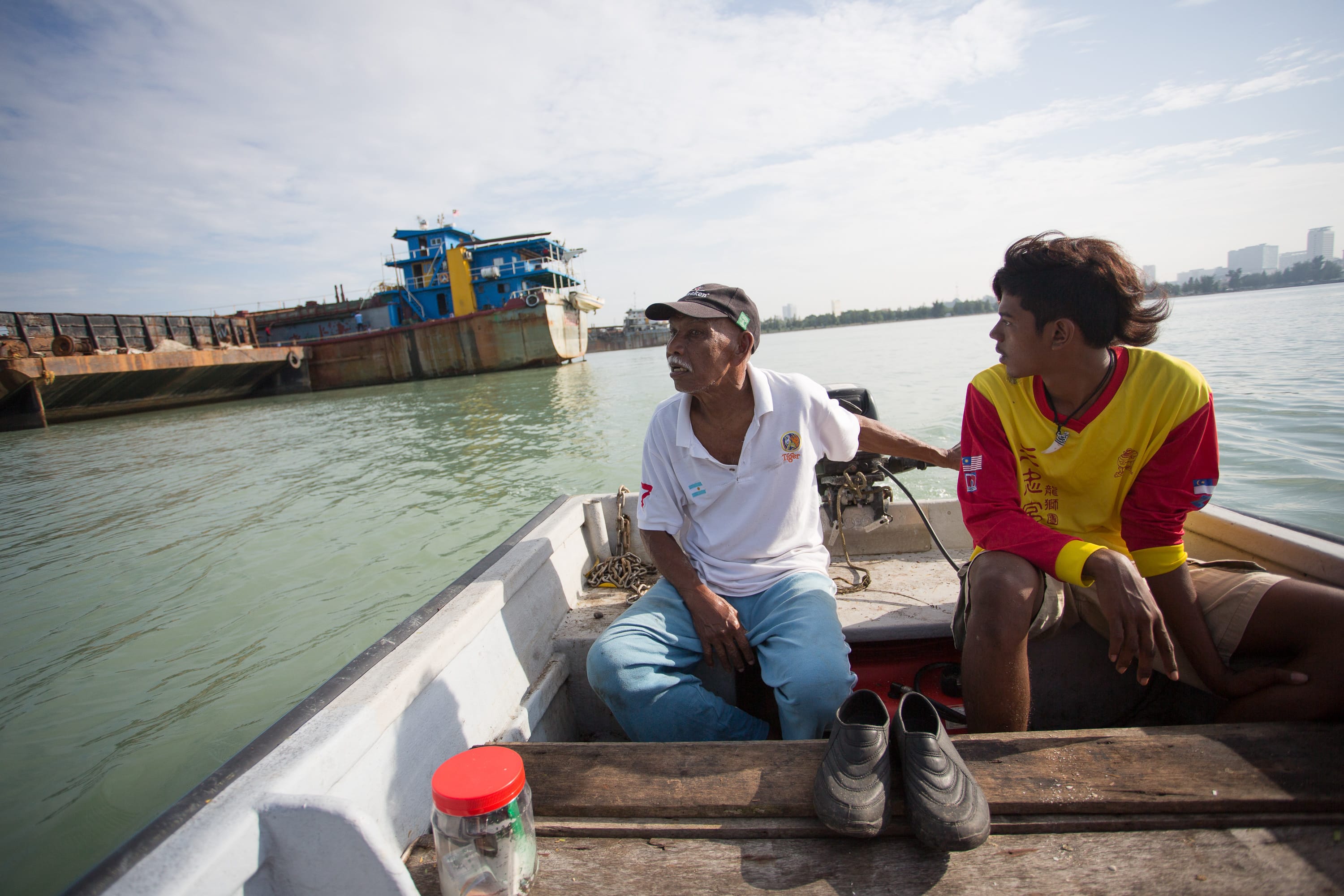 Maurice Pereira (left) and his grandson Jeremy, in his fishing boat on the seas around the Portuguese Settlement in Malacca. Photo by Desmond Lui. Courtesy of Melissa De Silva.