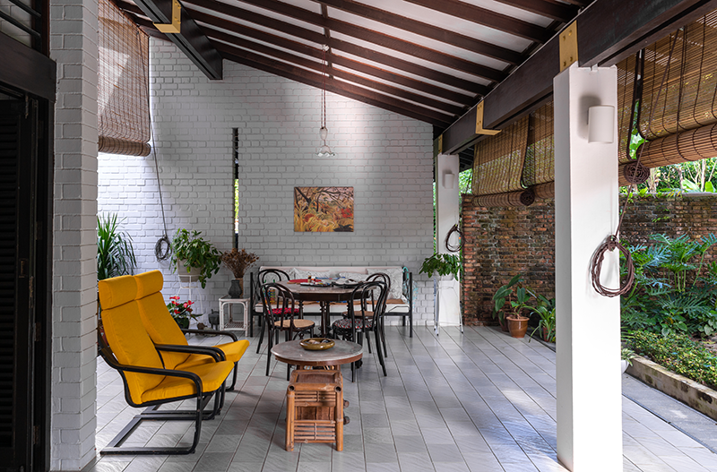A view of the veranda and the sloping roof, 2022. On the right is a wall made of red bricks salvaged from the former Raffles Institution building on Bras Basah Road. Courtesy of Dr Lee Peng Hui.