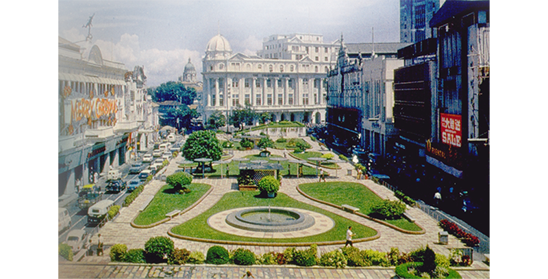 Raffles Place in 1965. The Overseas Union Bank building is on the extreme left and Robinsons department store just next to it. In the middle is the Chartered Bank building with the dome, while the tall building on the right is Bank of China. Arshak C. Galstaun Collection, courtesy of National Archives of Singapore.