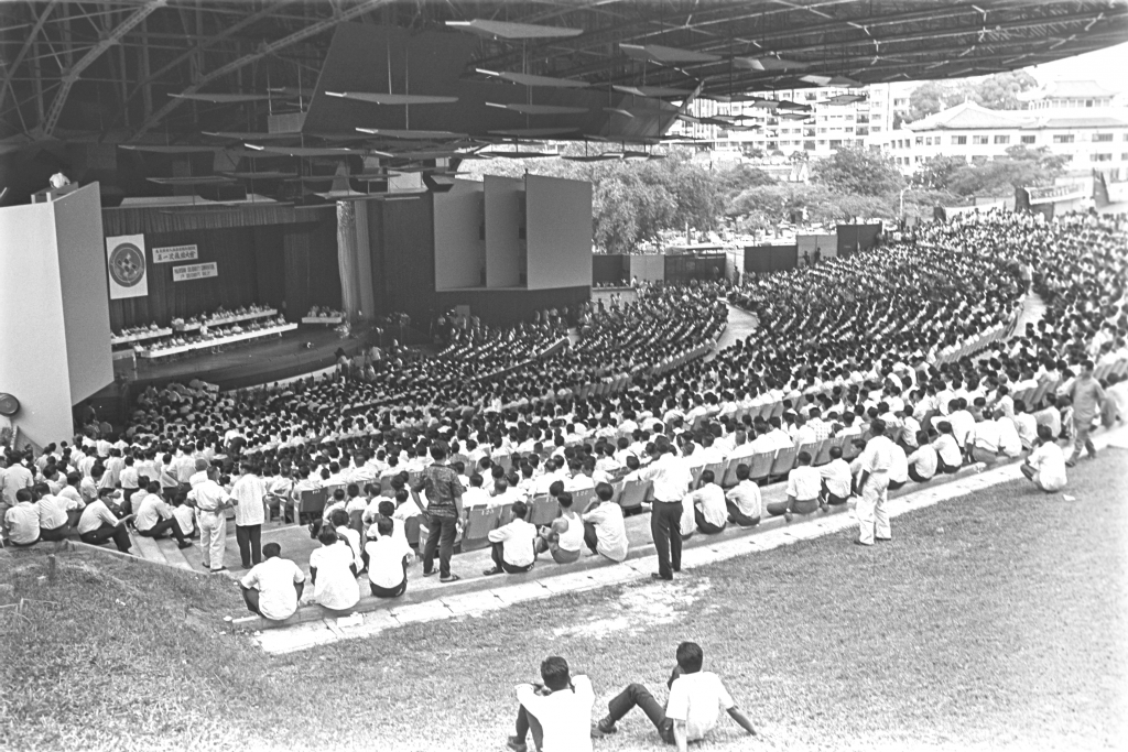The National Theatre, as seen during the 1965 Malaysian Solidarity Convention. The open-plan design of the theatre had a particular quirk; it allowed non ticket-holders perched on the hill outisde the theatre to watch the events for free. Ministry of Information and the Arts Collection, courtesy of National Archives of Singapore.