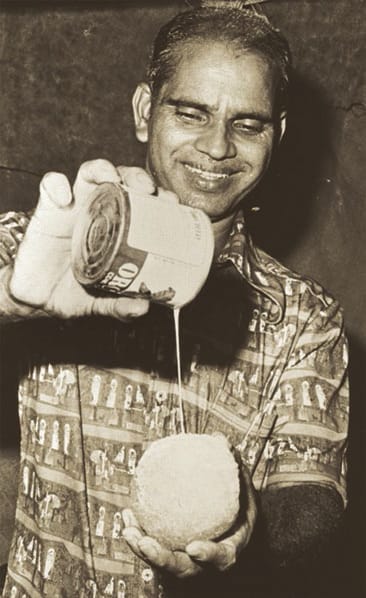 An Indian ice seller drizzling multi-coloured syrups and swirls of creamy evaporated milk over an ice ball, 1978. Ministry of Information and the Arts Collection, courtesy of National Archives of Singapore.