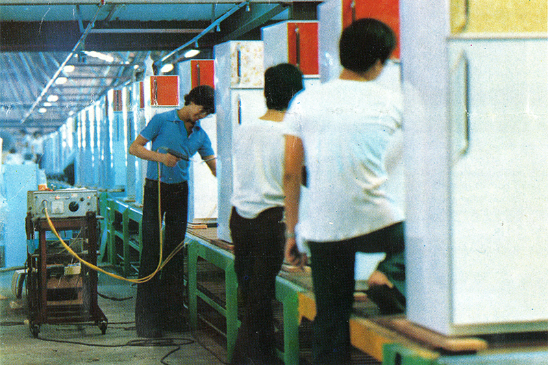 Pan-Electric factory staff working on the Permadoor model of refrigerators in an assembly line. Image reproduced from The Pan Electric News: A Pan-Electric Industries Ltd. Staff Journal, vol 1, no. 1 (Singapore: Pan-Electric, [1979]–), 3. (From PublicationSG).