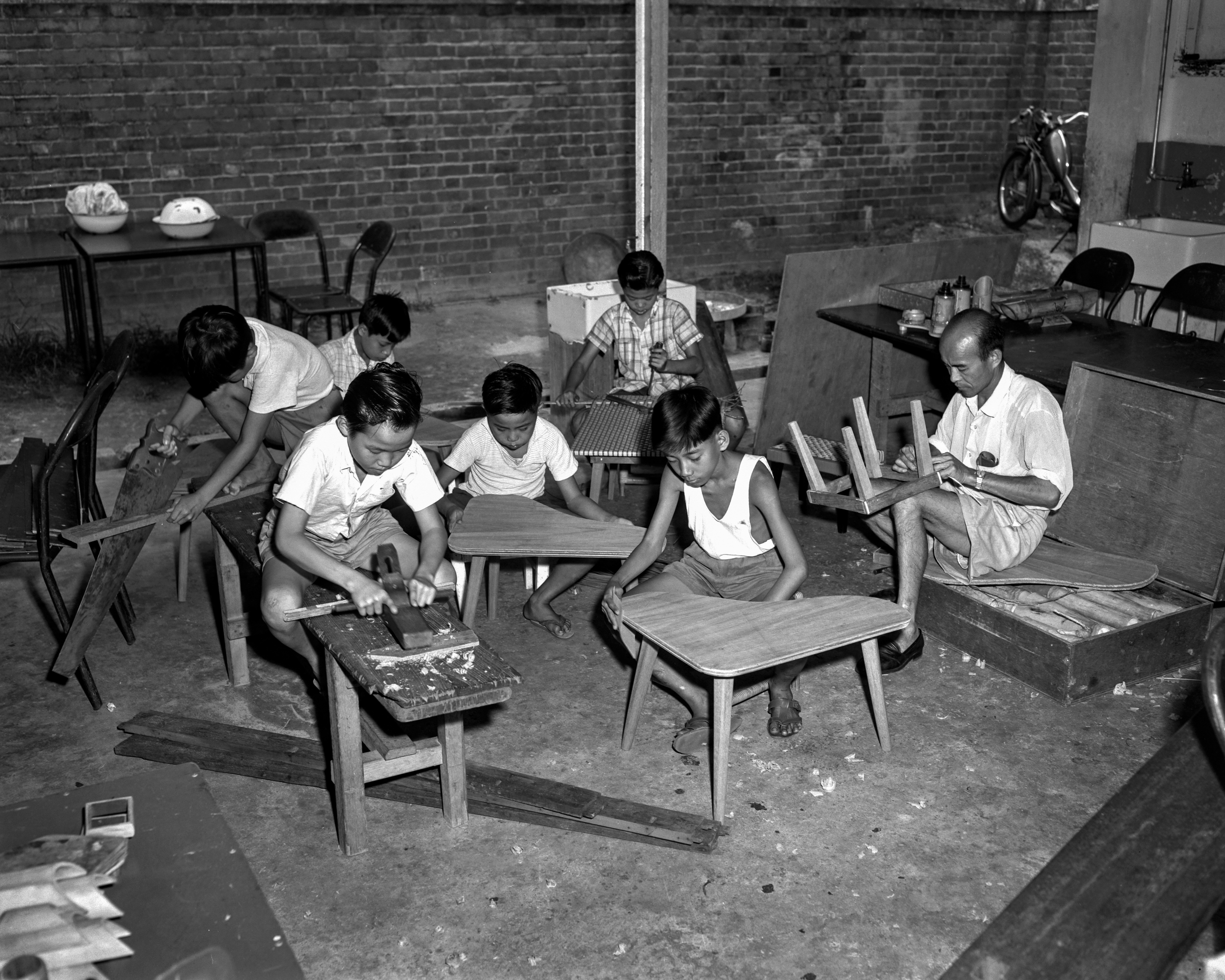 A carpentry lesson for older children in progress, 1962. Ministry of Information and the Arts Collection, courtesy of National Archives of Singapore.