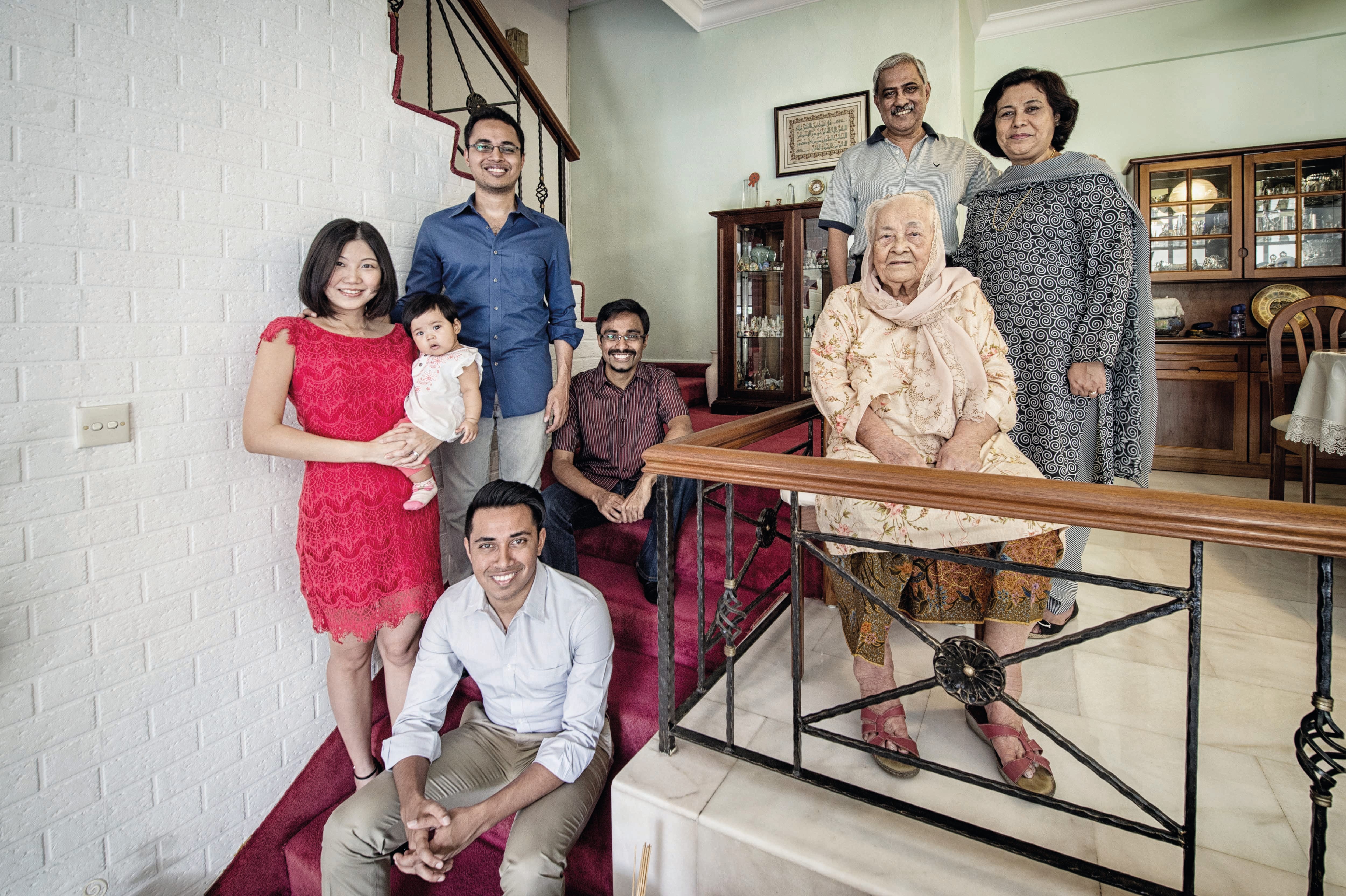 Adam Maniam (standing, left), with wife Yap Cuixian and their daughter Amelia Ri-En, his elder brother Aaron (seated, top) and younger brother Ashraf, together with his father Sydney (right), mother Bibe Zoolaha and maternal great-grandmother Chan Bibi. Adam is a Tamil-Eurasian-Malay-Pakistani lawyer with a Catholic Tamil grandfather and a Eurasian grandmother.